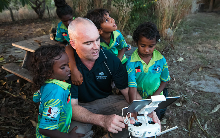 Reef Authority staff instructing children on using a drone