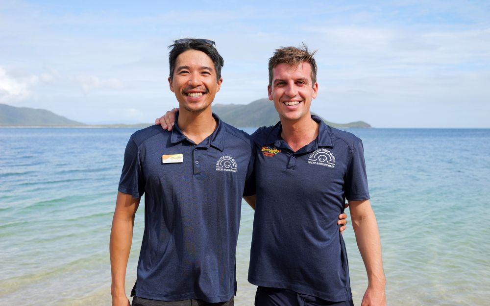 Two men in navy polos with Master Reef Guide logos.
