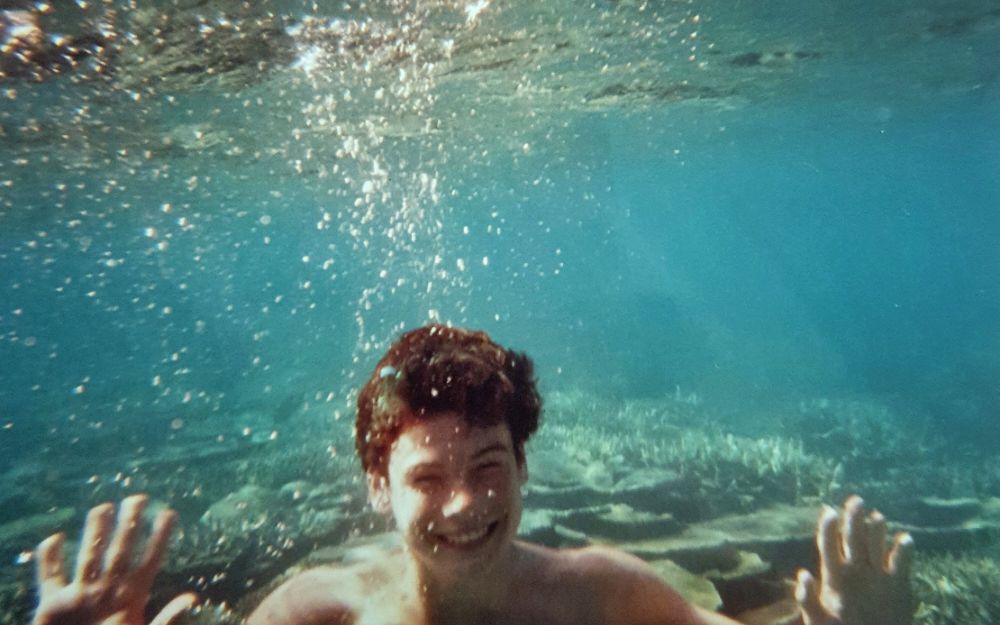 Boy swimming underwater in the Great Barrier Reef