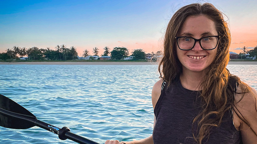 Alice kayaking with beach in background