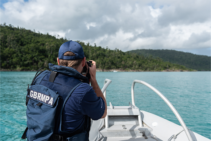 Man conducting field operations with camera on board vessel