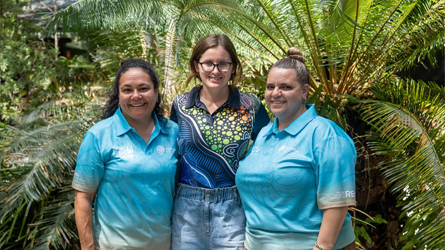 Alice standing between participants at TUMRA workshop