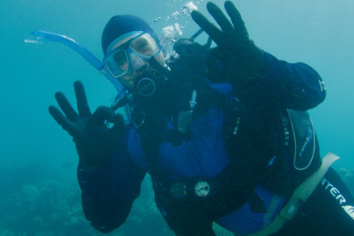 Josh Thomas underwater in full scuba gear