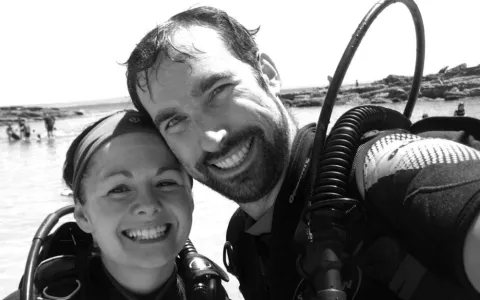 Black and white photo of two divers taking a selfie.