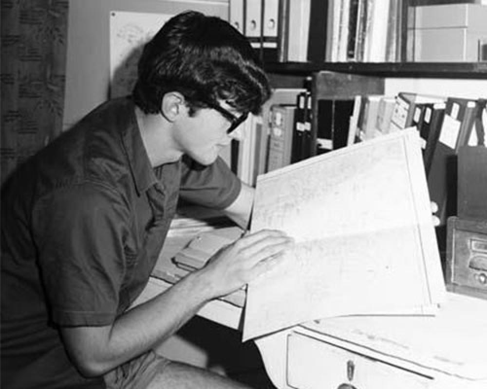 Ed Hegerl reading chart at desk