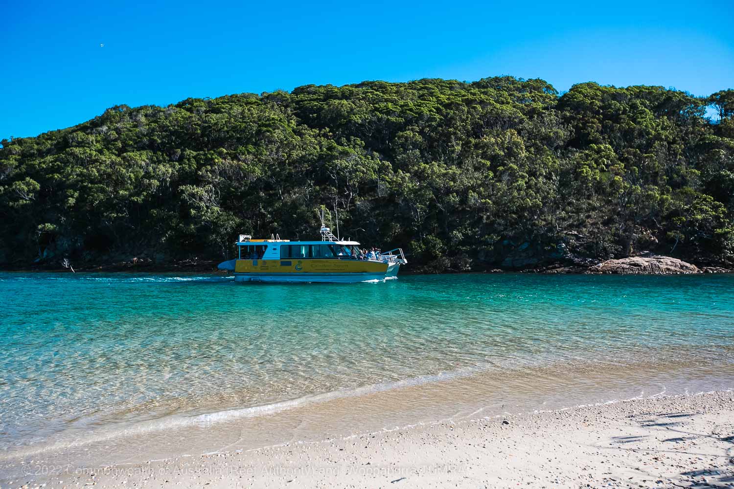 Woppaburra TUMRA, boat pulling up in a bay photo - Commonwealth of Australia (Reef Authority)